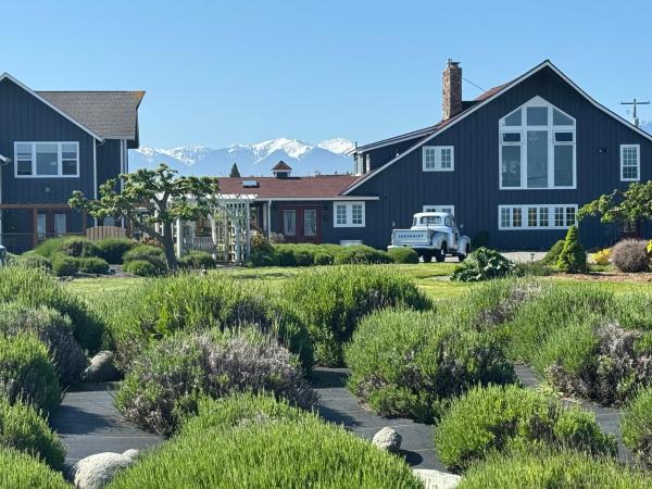 The photo shows the Dungeness Barn House Bed and Breakfast at Two Crows Farm located in the city of Sequim.