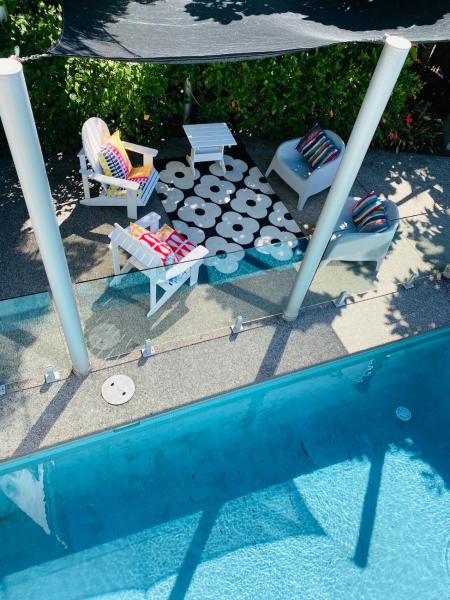 The photo shows the Stanmore Bay lush garden with pool, close to beach located in the city of Stanmore Bay.