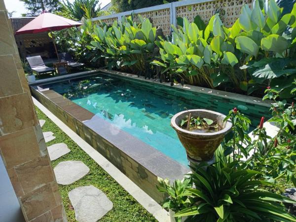Na fotografii je vidět objekt Deluxe Room Puri Uma Dewi room only nacházející se ve městě Ubud.