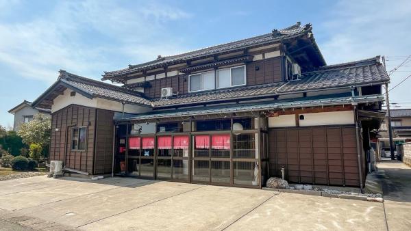 The photo shows the いろむすびの宿 located in the city of Murakami.