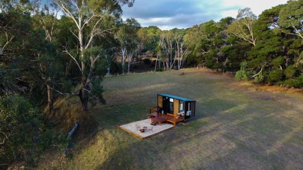 The photo shows the Boston's Retreat by Tiny Away located in the city of Bald Hills.