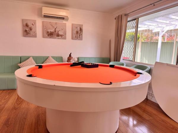 The photo shows the Fairyland Getaway- at Central Coast with XXXL hot Jacuzzi & Fun - Round pool table and Slide bunk bed located in the city of Narara.