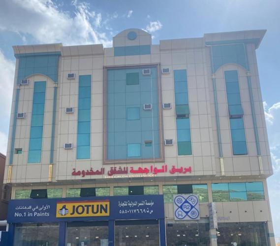 The photo shows the بريق الواجهة للشقق المخدومة - أبها located in the city of Abha.