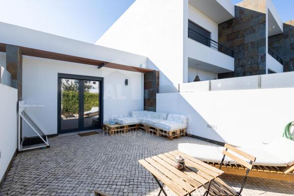 The photo shows the Valentin House by ACasaDasCasas located in the city of Ribamar.