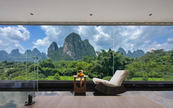 The photo shows the Riverside Bamboo Frest Hotel located in the city of Xingping.