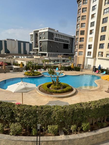 Na fotografii je vidět objekt elegant one bedroom hotel appartment Porto New Cairo pool access nacházející se ve městě Káhira.