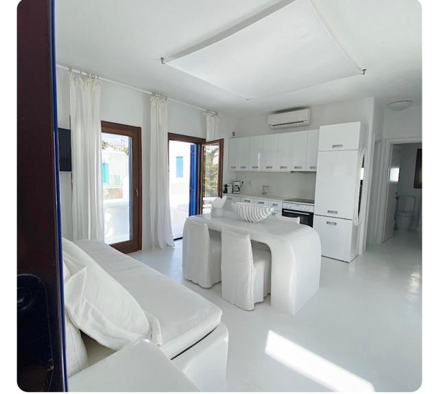 White luxury suite with shared pool downtown by Mykonos Eight