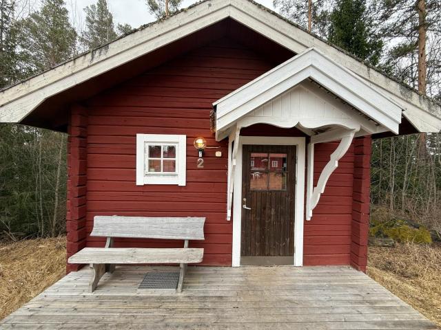 Small Timber House near stream, holy place near Church