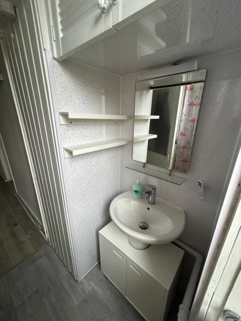 Bright bedroom with king side bed and share bathroom