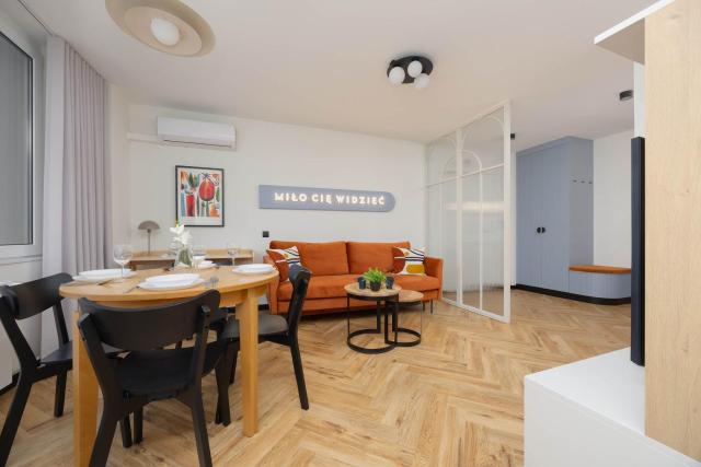 Blue and Orange Apartment with Desk in the Warsaw Center by Noclegi Renters