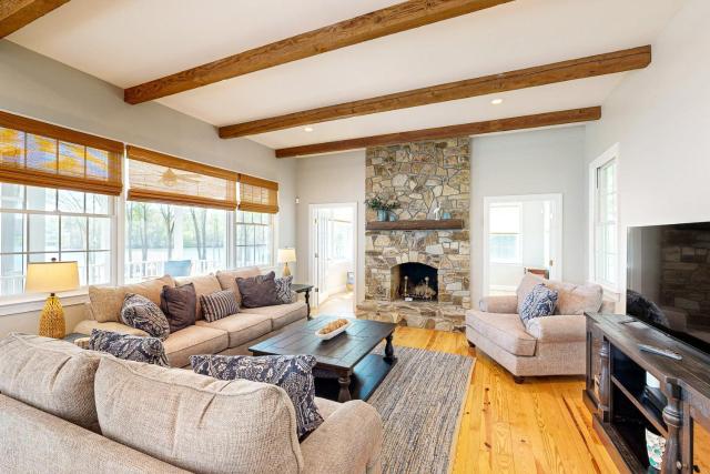 Lakefront home with private dock, kayaks, beach, badminton, firepit, & deck