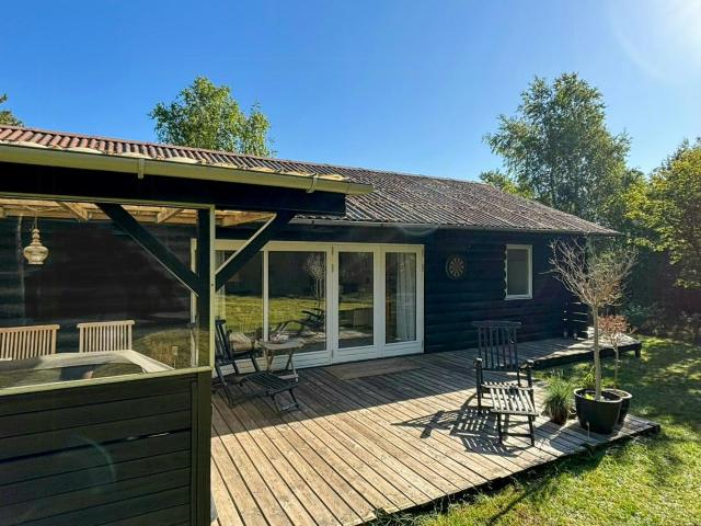 Log cabin on large nature plot with sun