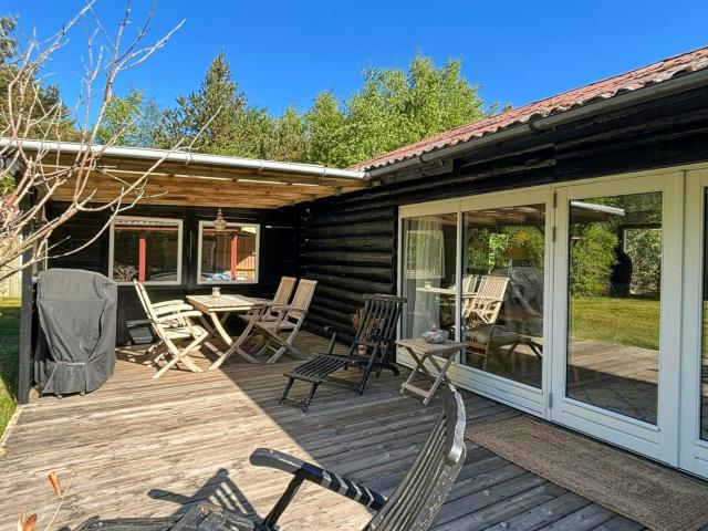 Log cabin on large nature plot with sun