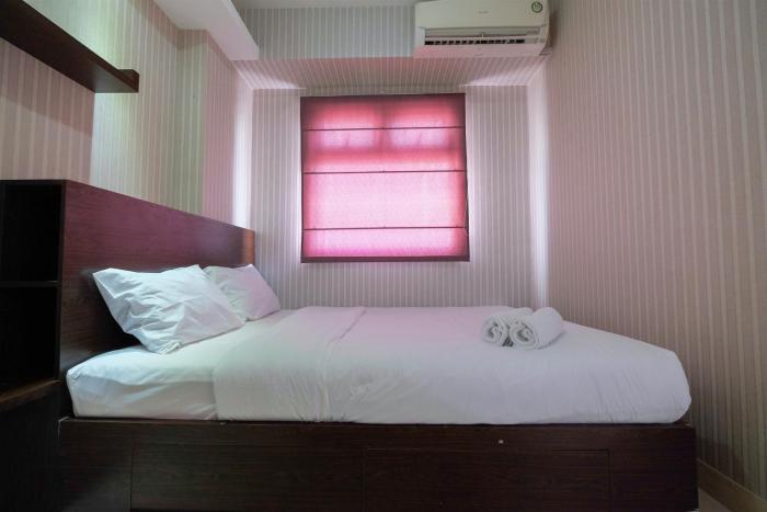 Homey and Relaxing 2BR Green Pramuka City Apartment By Travelio