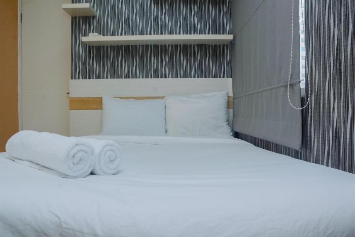 Minimalist 1BR with Pool View at Bassura City Apartment By Travelio