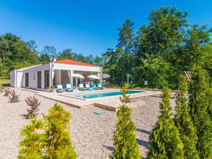 Modern villa with swimming pool and fenced garden