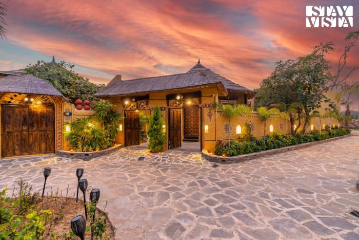 StayVistas Majestic Mud House - Rajasthani Architecture with Modern Amenities, Outdoor Pool, Adventure Activities, and Spa