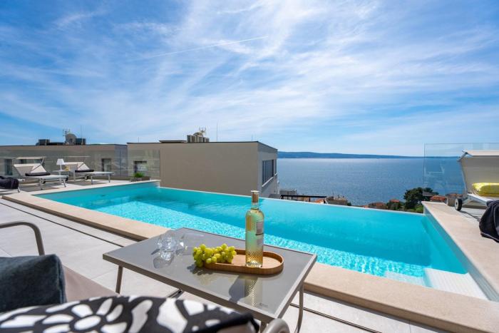 NEW! Three-bedroom Villa Sunshine with a heated pool, media room, and views of the sea