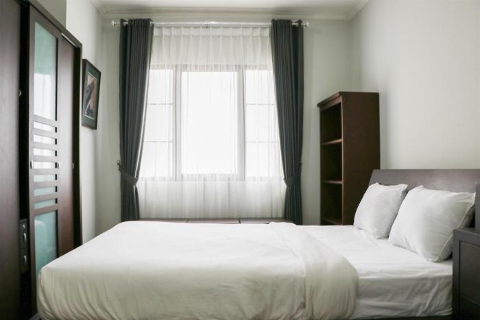 Cozy Living and Modern 2BR Puri Garden Apartment By Travelio