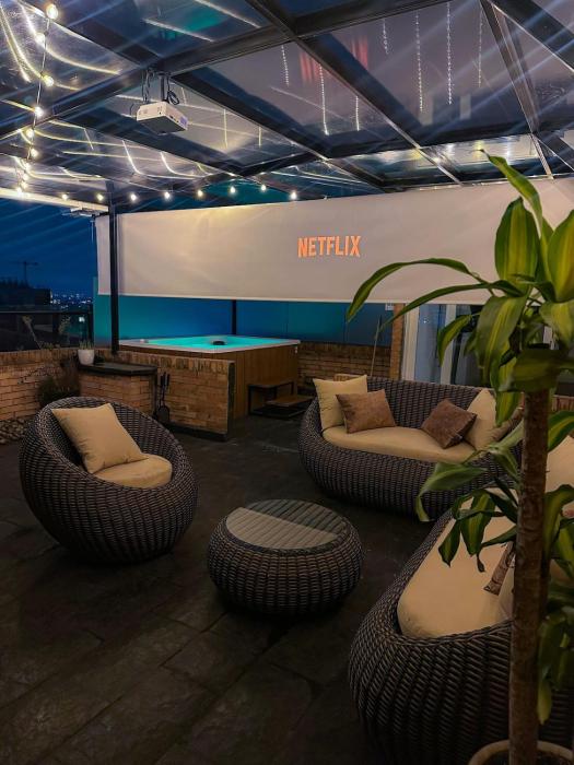 A penthouse with a luxury Jacuzzi and panoramic view