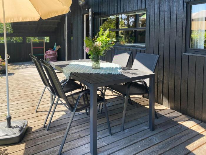 Black Wooden Cottage Near Forest And Beach