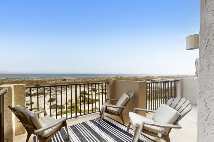 Oceanfront townhome with a furnished balcony, outdoor pool, & tennis