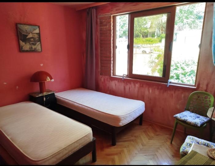 Room with two beds and shared bathroom