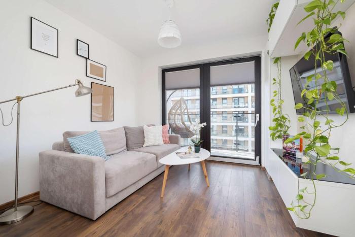 Light Grey Apartment in Cracow with Furnished Balcony by Noclegi Renters