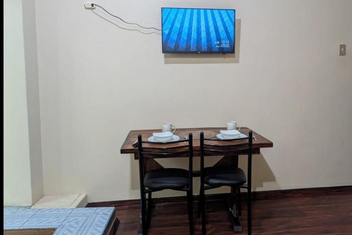 Suite Práctica de Dos Ambientes Cocina y Sofá Cama