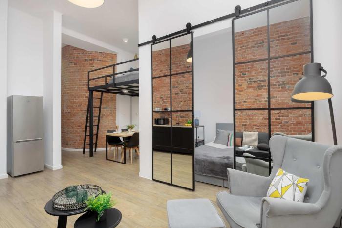 Stylish Apartment with Mezzanine, next to Metro Station by Noclegi Renters