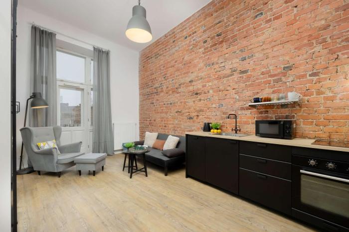 Stylish Apartment with Mezzanine, next to Metro Station by Noclegi Renters