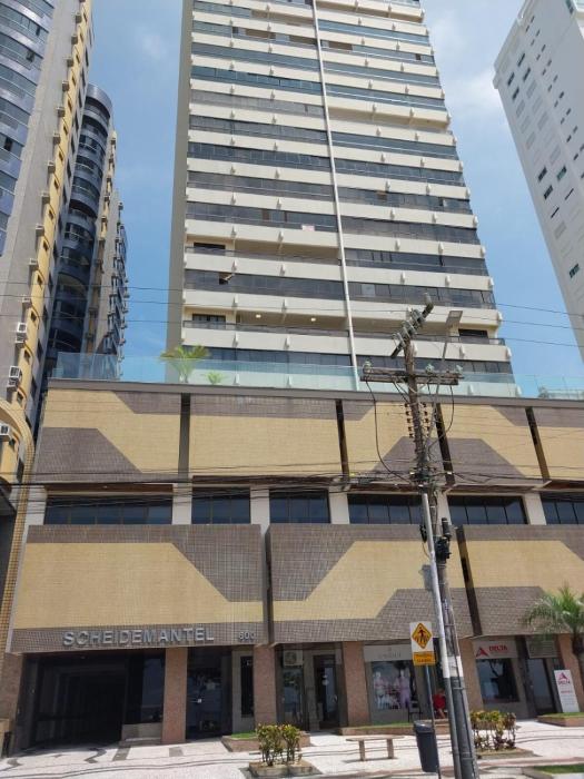 Building facing the sea Side view of Ferris Wheel