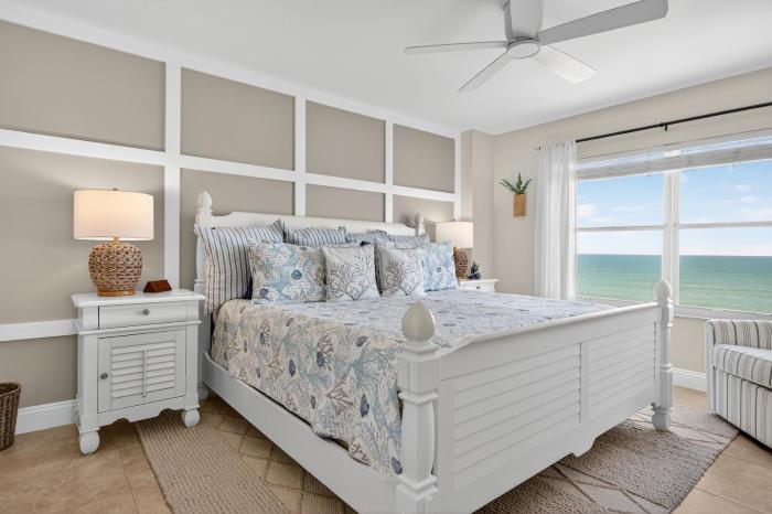 Renovated direct oceanfront corner 22 with a large balcony, heated pool, and garage