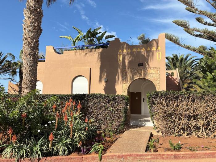 House in green oasis between sea and mountain