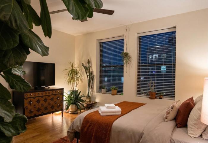 Sunlit Luxury 2BR Harlem Brownstone Retreat with Terrace Near Express Trains