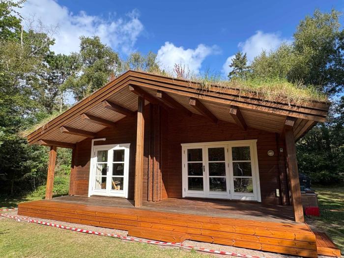 Traditional Log House Near Beach And Forest