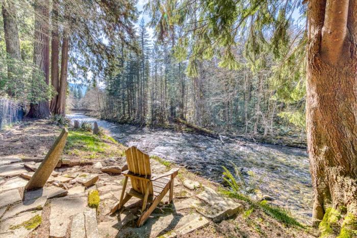 Dog-friendly riverfront home with a wood-burning fireplace & views