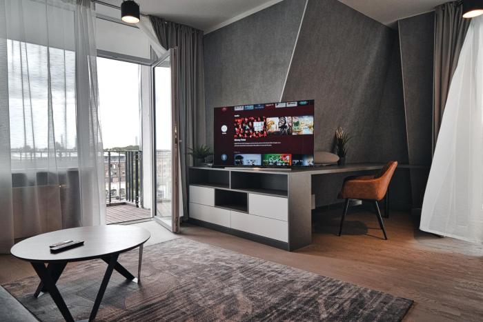 Modern central Riga apartment with balcony, gym access, dedicated parking, kitchen & AC