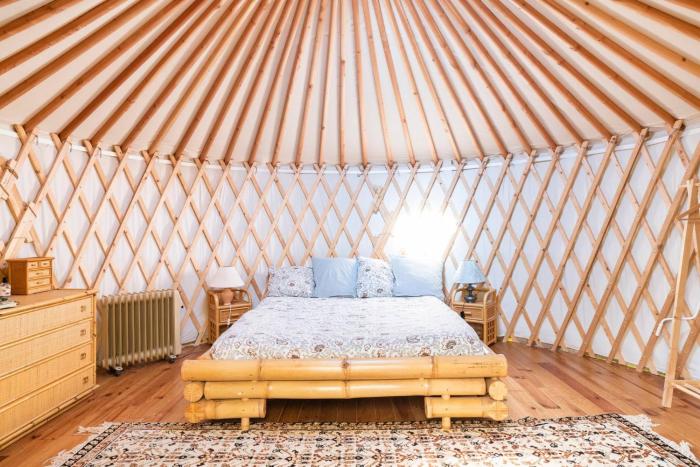 A yurt among olive trees and the sea