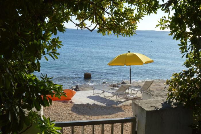 Apartment PALATISA on the beach with sunbeds, umbrella and canoe