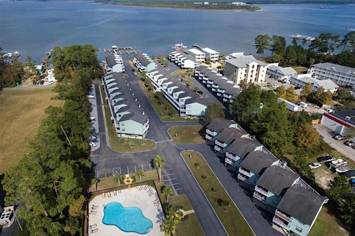 Calming water view condo with full kitchen balcony pool & TV - close to park
