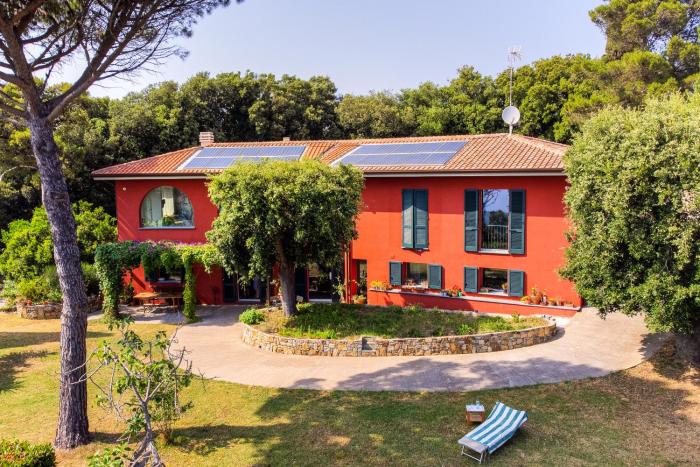 la villa rossa nestled between the hills and the sea