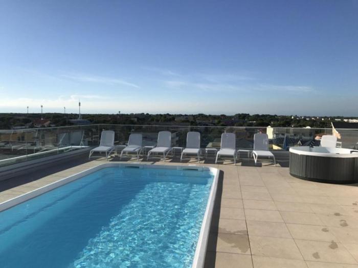 Comfortable accommodation featuring a rooftop pool