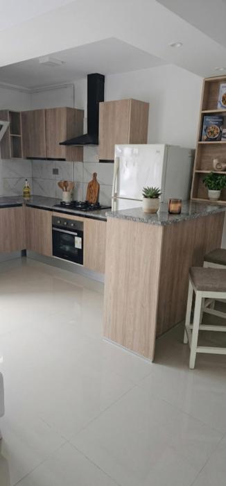 A one-bedroom apartment with a living room, kitchen, and balcony