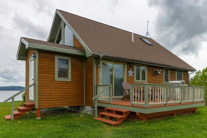 Two lakefront dog-friendly cabins on four acres with porches, dock, & lake views