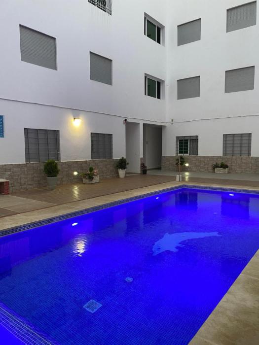 residential unit with a swimming pool and parking