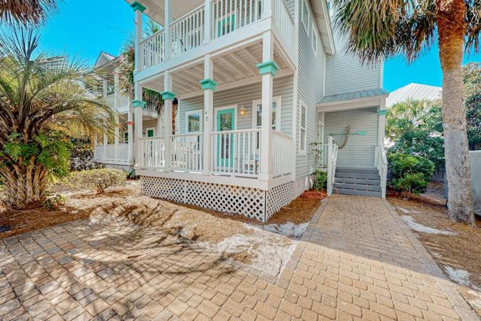 3-story home with heated outdoor pool BBQ area balconies partial ocean views
