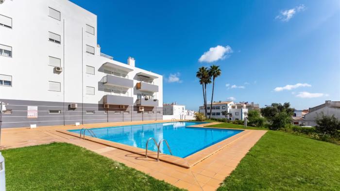Quiet 2BR Retreat with Pool & Balcony by LovelyStay