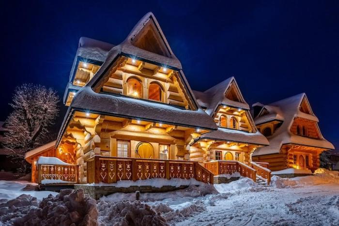 A large mountain-style house with a spa area