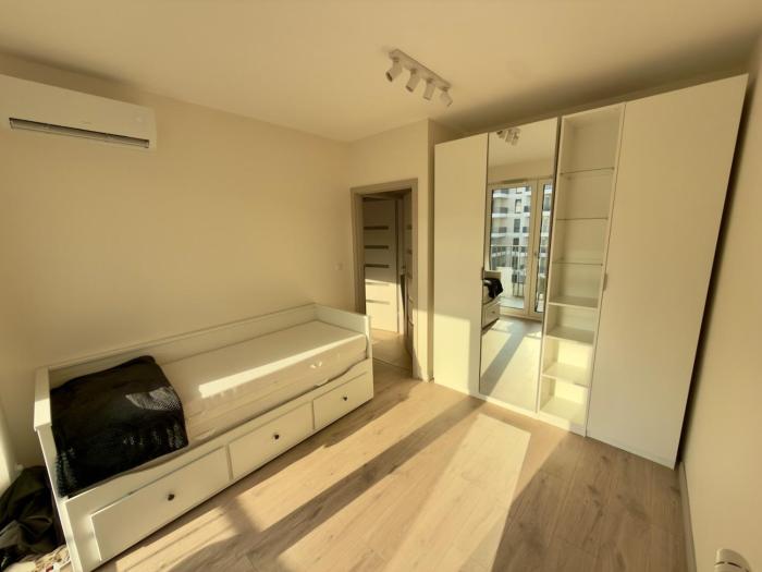 A modern apartment with air conditioning and a balcony
